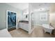 Modern bathroom features a vanity with granite counters, tub, and walk-in closet at 2303 S Occident St, Tampa, FL 33629