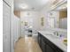 Bright bathroom featuring vanity, long mirror, and tile floor that leads to bedroom at 2303 S Occident St, Tampa, FL 33629
