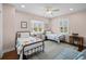 Cozy bedroom with twin beds, wood floors, ceiling fan and plenty of natural light at 2303 S Occident St, Tampa, FL 33629