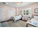 Bedroom featuring twin bed, closet, ceiling fan and plenty of natural light at 2303 S Occident St, Tampa, FL 33629