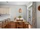 Cozy dining area features a wooden table, stylish lighting, and access to the backyard at 2303 S Occident St, Tampa, FL 33629