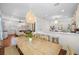 Open-concept dining area connected to the kitchen and living room with hardwood flooring at 2303 S Occident St, Tampa, FL 33629