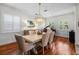 Elegant dining room with wood floors, decorative chandelier and grand piano provides a sophisticated ambiance at 2303 S Occident St, Tampa, FL 33629
