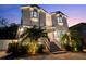 Two-story home featuring well-manicured landscape, illuminated exterior and curb appeal at 2303 S Occident St, Tampa, FL 33629