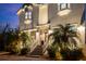 Two-story home featuring manicured landscaping, with an illuminated exterior at 2303 S Occident St, Tampa, FL 33629