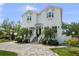 Charming two-story home featuring manicured lawn, brick driveway and classic curb appeal at 2303 S Occident St, Tampa, FL 33629