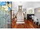 Inviting foyer with hardwood floors, staircase, fireplace, and decorative front door at 2303 S Occident St, Tampa, FL 33629