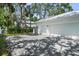The exterior shows a two-car garage and a paver driveway at 2303 S Occident St, Tampa, FL 33629