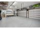 Well-organized garage with epoxy flooring, overhead storage, and space for multiple cars at 2303 S Occident St, Tampa, FL 33629