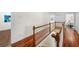 Upstairs hallway with hardwood floors and access to bedrooms and other living areas at 2303 S Occident St, Tampa, FL 33629