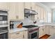 Bright kitchen features stainless appliances and custom cabinets providing both style and functionality at 2303 S Occident St, Tampa, FL 33629