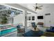 Screened-in lanai overlooking the pool with comfortable seating and a ceiling fan at 2303 S Occident St, Tampa, FL 33629