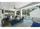 Enclosed lanai with comfortable seating, ceiling fan, outdoor grill, and view of the pool at 2303 S Occident St, Tampa, FL 33629