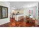 View of the kitchen and dining area, featuring hardwood floors and stylish decor at 2303 S Occident St, Tampa, FL 33629