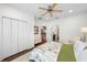 Spacious main bedroom with hardwood floors, closet, upholstered bench, and view of the stairway at 2303 S Occident St, Tampa, FL 33629