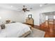 Bright main bedroom with hardwood floors, a ceiling fan, and access to a hallway at 2303 S Occident St, Tampa, FL 33629