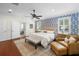 Spacious main bedroom showcasing hardwood floors, ensuite bathroom, and large windows at 2303 S Occident St, Tampa, FL 33629