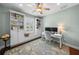 Bright office space featuring custom built-ins, window seat, desk, ceiling fan, and a calming blue palette at 2303 S Occident St, Tampa, FL 33629