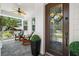 Inviting porch with rocking chairs, stylish décor, and a decorative front door at 2303 S Occident St, Tampa, FL 33629