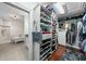 Spacious walk-in closet with built-in storage shelves and hanging rods and bathroom at 2303 S Occident St, Tampa, FL 33629