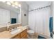 Bathroom featuring a granite countertop vanity and a shower with a white curtain and blue accents at 2402 Blue Stone Ct, Valrico, FL 33594