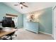 Bright bedroom with vaulted ceiling features modern decor, a ceiling fan and light blue walls at 2402 Blue Stone Ct, Valrico, FL 33594