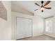 Cozy bedroom with natural light, features a ceiling fan, closet, and a window with plantation shutters at 2402 Blue Stone Ct, Valrico, FL 33594