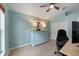 Bright bedroom with vaulted ceiling features modern decor, a ceiling fan and light blue walls at 2402 Blue Stone Ct, Valrico, FL 33594