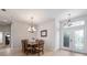 Inviting dining area with a rustic wood table and a stylish chandelier, enhancing the home's charm and appeal at 2402 Blue Stone Ct, Valrico, FL 33594
