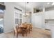 Dining room with table, chandelier and view to pool at 2402 Blue Stone Ct, Valrico, FL 33594