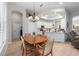Bright Dining area features chandelier, access to kitchen, and lots of natural light at 2402 Blue Stone Ct, Valrico, FL 33594