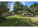 Lush front lawn with mature trees, offering a serene and inviting curb appeal at 2402 Blue Stone Ct, Valrico, FL 33594