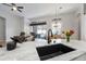 Bright kitchen features a granite island with a sink, opening to living area with comfortable seating and natural light at 2402 Blue Stone Ct, Valrico, FL 33594