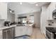 The modern kitchen opens to the living area and features granite countertops, white cabinets, and stainless steel appliances at 2402 Blue Stone Ct, Valrico, FL 33594