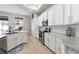 Beautiful kitchen boasts white cabinets, granite countertops, stainless steel appliances, and an eat-in area at 2402 Blue Stone Ct, Valrico, FL 33594