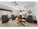 Open living room with hardwood floors, lots of seating and view of the pool at 2402 Blue Stone Ct, Valrico, FL 33594
