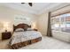 Main bedroom features a ceiling fan, tray ceiling, and lots of natural light at 2402 Blue Stone Ct, Valrico, FL 33594