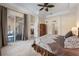Carpeted primary bedroom features large windows with a view to the outdoor lanai at 2402 Blue Stone Ct, Valrico, FL 33594