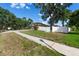 Charming single-Gathering home featuring a well-maintained yard, white fence, and mature shade trees at 2402 Blue Stone Ct, Valrico, FL 33594