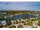 Expansive aerial view of the home's location on a waterfront canal, surrounded by palm trees and other residences at 2487 W Bay Isle Se Dr, St Petersburg, FL 33705