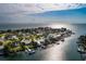 Wide aerial shot of the coastal community, highlighting waterfront homes with private docks along the tranquil canals and ocean views at 2487 W Bay Isle Se Dr, St Petersburg, FL 33705