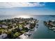 Stunning aerial view of waterfront homes with boat docks, surrounded by lush landscaping and serene canal waters at 2487 W Bay Isle Se Dr, St Petersburg, FL 33705