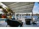 Waterfront back patio under cover with seating, a coffee table, and beautiful views at 2487 W Bay Isle Se Dr, St Petersburg, FL 33705