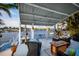 Waterfront back patio with plentiful seating, a coffee table, and beautiful views at 2487 W Bay Isle Se Dr, St Petersburg, FL 33705