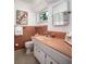 Vintage pink-tiled bathroom featuring a toilet, sink with white cabinets, and a large mirror at 2487 W Bay Isle Se Dr, St Petersburg, FL 33705