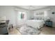 Bright bedroom with large windows, white iron bed, and neutral-toned decor at 2487 W Bay Isle Se Dr, St Petersburg, FL 33705