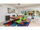 Bright dining area with modern light fixture, adjacent to waterfront view, creates an inviting space for dining at 2487 W Bay Isle Se Dr, St Petersburg, FL 33705