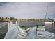 Adirondack chairs with great view looking out from the home's private dock at 2487 W Bay Isle Se Dr, St Petersburg, FL 33705