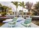 Waterfront home featuring a private dock with lounge chairs and a boat for relaxation at 2487 W Bay Isle Se Dr, St Petersburg, FL 33705