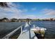 Wide shot of a waterfront property's dock with chairs, boat, and tranquil water views at 2487 W Bay Isle Se Dr, St Petersburg, FL 33705